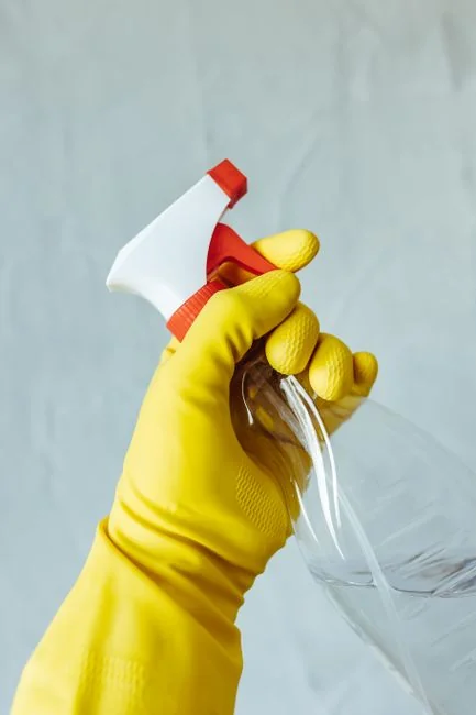 creative person-holding-yellow-plastic-spray-bottle-zmnefoi3k