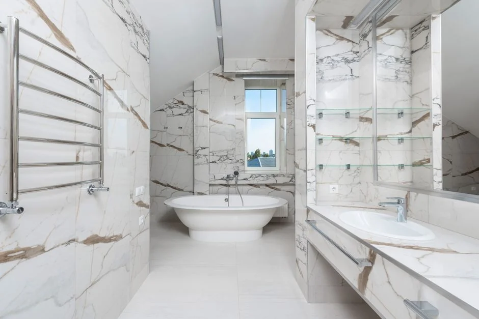 Anonymous person in yellow rubber gloves using simple sponge for cleaning mirror in bathroom
